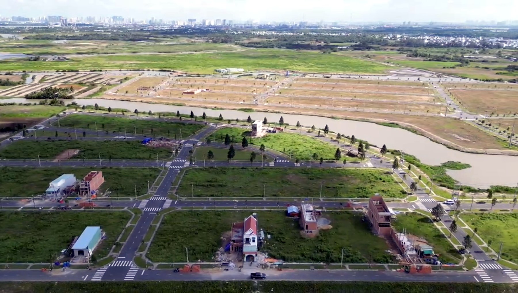 Toàn cảnh dự án — đường nội bộ đã hoàn thiện, nhiều nhà đã xây (ảnh flycam, không phải ảnh riêng của lô)